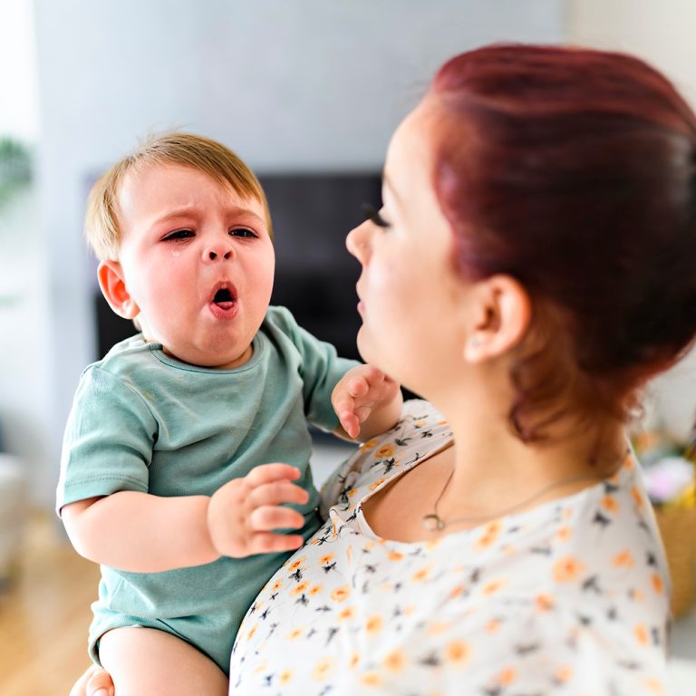 Mother holding sick child